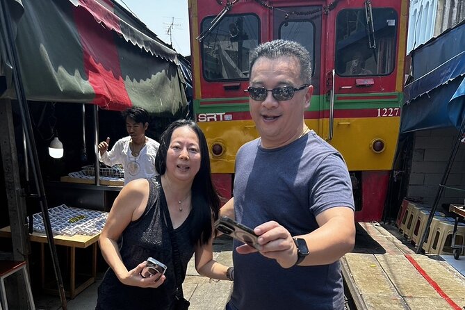Damnoen Saduak Floating Market & Maeklong Railway From Bangkok - Maeklong Railway Market and the train that cuts through it
