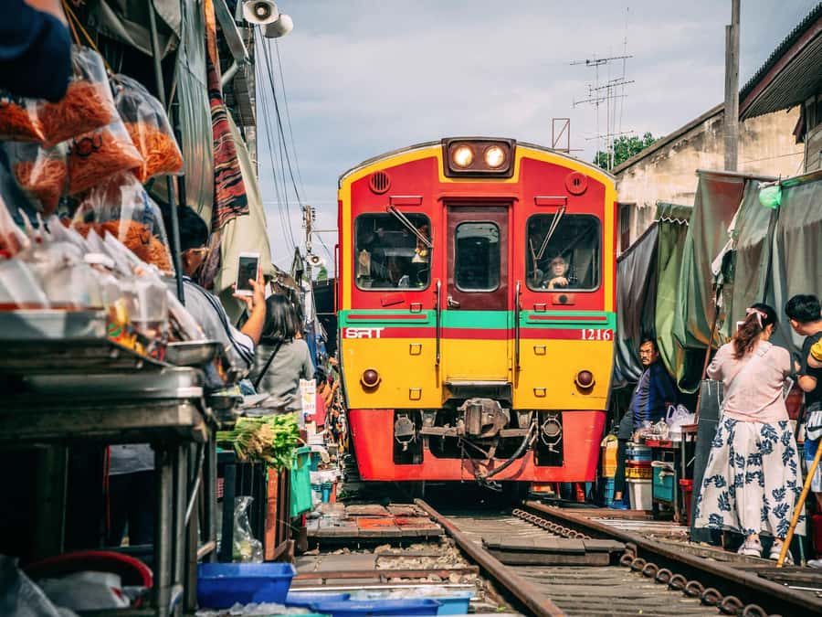 From Bangkok: Maeklong Railway and Floating Market Day Tour - Maeklong Railway Market and the famous train passage