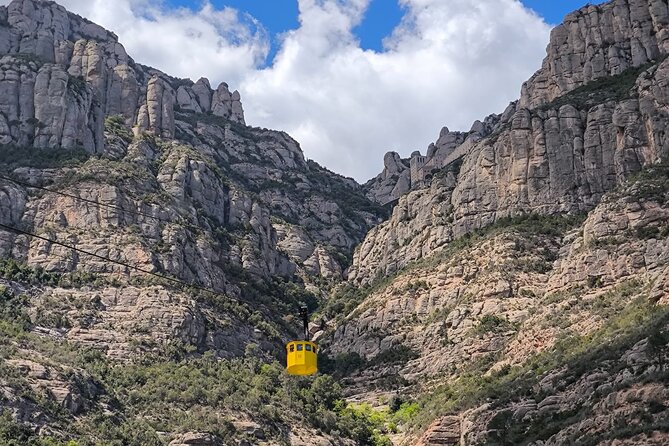 Montserrat Tour by Train with Cable Car and Cogwheel - The first look at Montserrat’s monastery