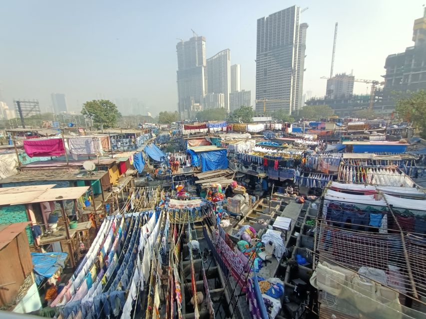 Mumbai: Dhobi Ghat Tour with Dharavi and Train Ride Options - Washing, drying, and pressing by hand