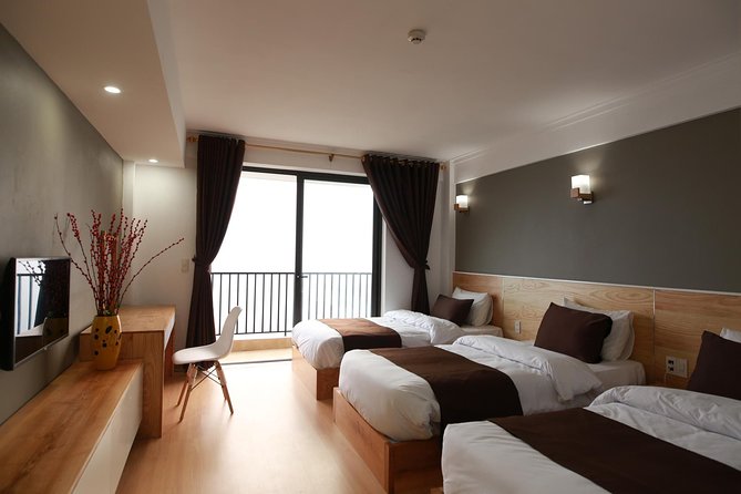 Sapa 2 Days 1 night By Bus/Train - Overnight in Hotel 3<em> With Mountain View – Leaving Hanoi early by bus’ /></p>
<p><p>Pickup is scheduled between 6:30 and 7:00 in the morning. The stated meeting point is Hanoi Opera House on Trang Tien Street, while pickup from your hotel or lodging is also offered. Confirm the exact pickup arrangement, since the difference between walking to the Opera House and waiting at your hotel can affect your morning.</p>
</p>
<p><p>The bus follows the highway toward Lao Cai, with a comfort stop around 9:30 and another stop near Lao Cai around 11:00. You reach Sapa at about 1:00 in the afternoon.</p>
</p>
<p><p>The journey is long, but the included vehicle has air conditioning, Wi-Fi, cold water, and wet tissues. Those are small comforts on a road trip of several hours. The road portion also explains why this is not really a two-day walking holiday. It is a short Sapa introduction built around fixed transport.</p>
</p>
<p><p>A train option is listed, but train tickets are not included. The extra cost is $15 each way for a shared four-person soft sleeper cabin. If you choose that option, ask exactly which legs of the journey it replaces. The main schedule supplied for the tour uses buses.</p>
</p>
<h2>First taste of Sapa town at 1:00</h2>
<p><img width="669" height="446" decoding="async" src=
